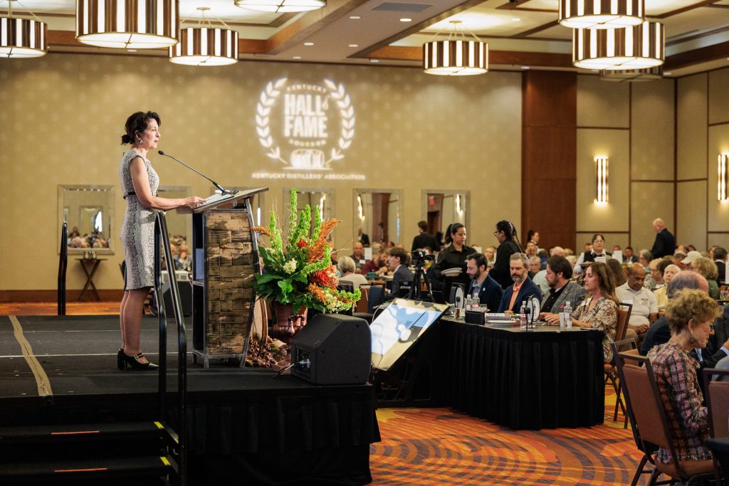 Emcee Susan Reigler addressing 330 guests at the 2026 Kentucky Bourbon Hall of Fame Induction Ceremony and Luncheon in Louisville