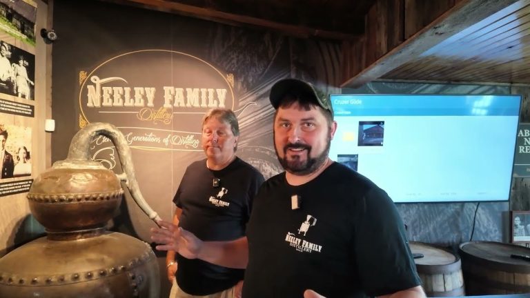 A copper pot still beside the Neeley Family Distillery sign, from Brewzle's episode